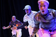 Members of a local dance group 'Via Katlehong' perform the 'Pantsula', a dance known for its syncopated, quick-stepping, low to the ground format at the Joburg Theatre in Johannesburg.