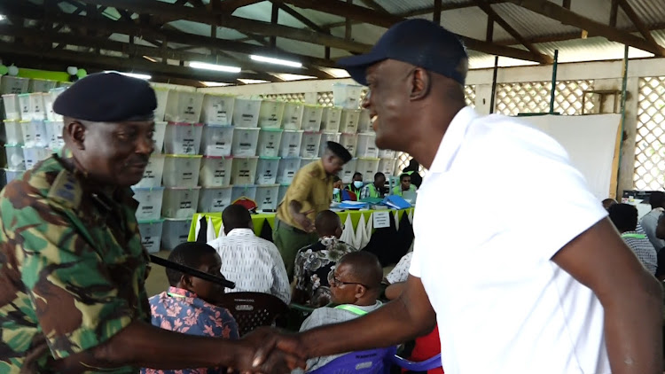 KIlifi Governor hopeful Gideon Mung'aro and a security official at Malindi constituency tallying centre w