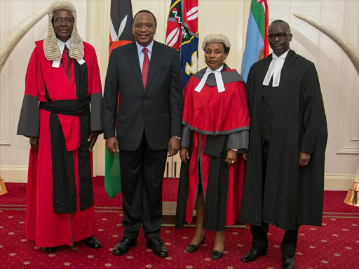 President Uhuru Kenyatta with Chief Justice David Maraga, the new Deputy Chief Justice Philomena Mwilu and Justice Isaac Lenaola during the swearing-in ceremony of the Deputy Chief Justice and Justice Lenaola as a Judge of the Supreme Court at State House.