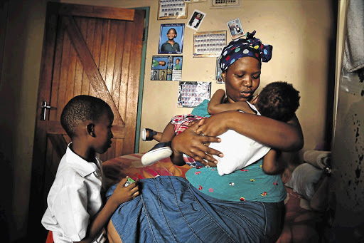 HOME SWEET HOME: Nomvula Zulu with two of her children, Siyabonga and Nkululeko, who live with her at the Thokoza Women's Hostel, in Durban