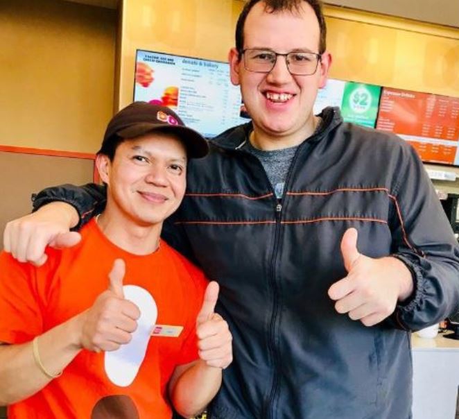 Dunkin Donuts employee Bryan Lara with Donald Simon.