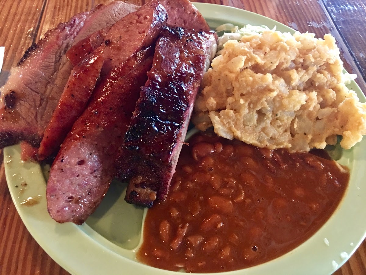 Brisket, sausage and ribs with slaw, potato salad and beans. All gluten free except for the mac and cheese, bread and desserts.