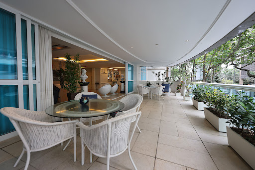 Terrace with white furniture and plants in this luxury apartment / penthouse for sale in Rio de Janeiro ($2,352,481 - 363 m²)