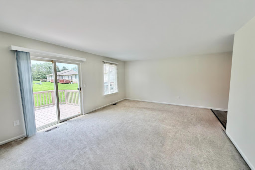 Living room with carpet and deck access - Luxury farmhouse for rent in Center Line, 2 bedrooms