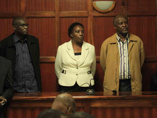 Former National Housing Corporation managing director James Ruitha, company secretary Elizabeth Mbugua and former finance manager Manasseh Wandabwa at Milimani law courts. /FILE