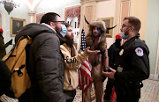 Police confront supporters of President Donald Trump as they demonstrate on the second floor of the US Capitol near the entrance to the Senate after breaching security defences, in Washington, US, January 6, 2021.