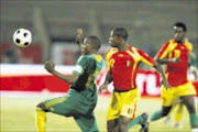 CHASING: Bafana Bafana's Sibusiso Zuma, left, fights for the ball with Guinea's Camara Alseny in their friendly game at Super Stadium last Tuesday. Pic. Antonio Muchave. 10/09/08. © Sowetan.