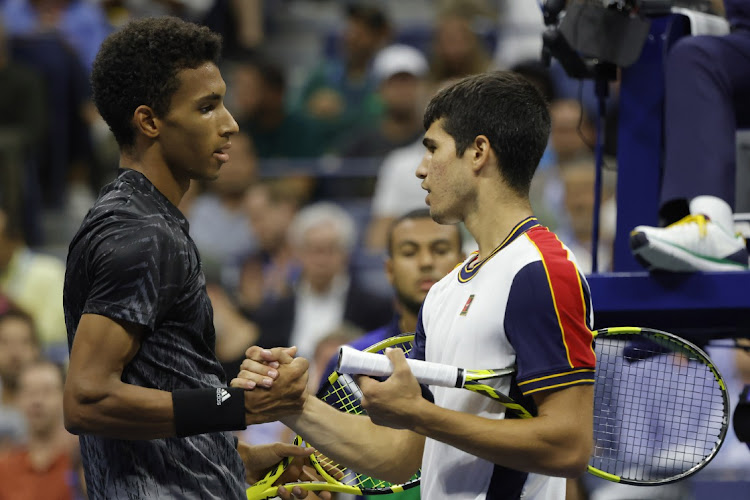 Felix Auger-Alliassime of Canada, left, shakes hands with Carlos Alcaraz after the Spaniard was forced to retire with an injury on day nine of the US Open on September 7, 2021