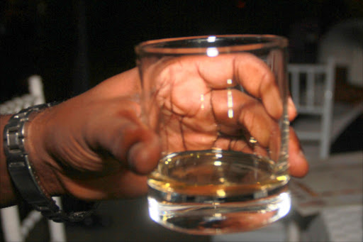 Man holding a glass of alcohol