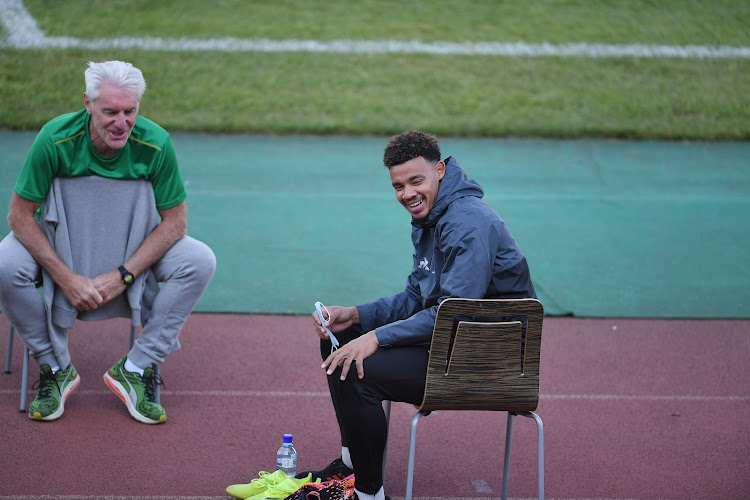 Bafana Bafana head coach Hugo Broos speaks to captain Ronwen Williams during a training session at Dobsonville Stadium in Johannesburg.