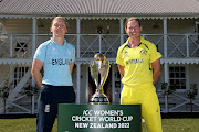 England captain Heather Knight (L) and her Australian counterpart Meg Lanning (R) pose with the World Cup Trophy ahead of the ICC Women's Cricket World Cup Final at Hagley Oval on Sunday.