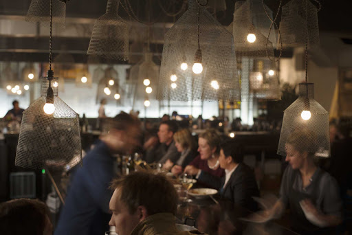 People dining at Coda, a trendy, industrial-chic basement space serving upscale Vietnamese fusion plates and set menus in Melbourne, Australia. 