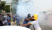 Police and football fan outside Orlando Stadium ahead of the Soweto derby between Orlando Pirates and Kaizer Chiefs. Fans protested to push for the reopening of stadiums on Saturday. It has been almost 2 years since supporters were allowed into stadiums due to the Covid-19 pandemic.