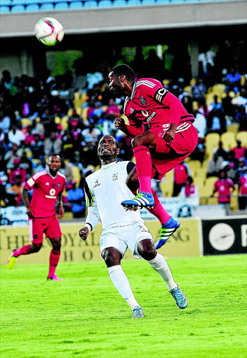 HEADED AWAY: Robert Ng'ambi of Platinum Stars watches as Pirates' Rooi Mahamutsa clears the ball away during last night's exciting clash in Phokeng Photo: Veli Nhlapo