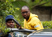 Activist Pastor Evan Mawarire is taken into a vehicle by police outside his home in Harare, Zimbabwe, January 16, 2019. 