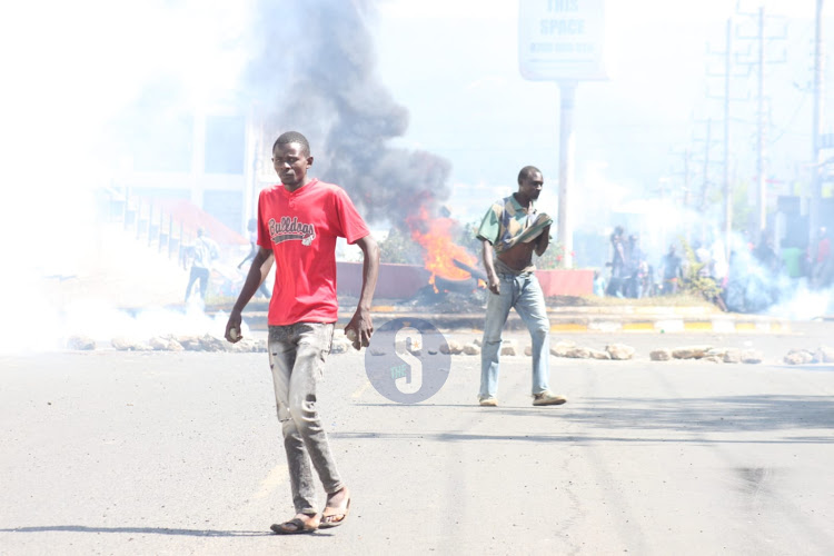 Protesters carrying placard near Jua Kali round-about on July 12, 2023.