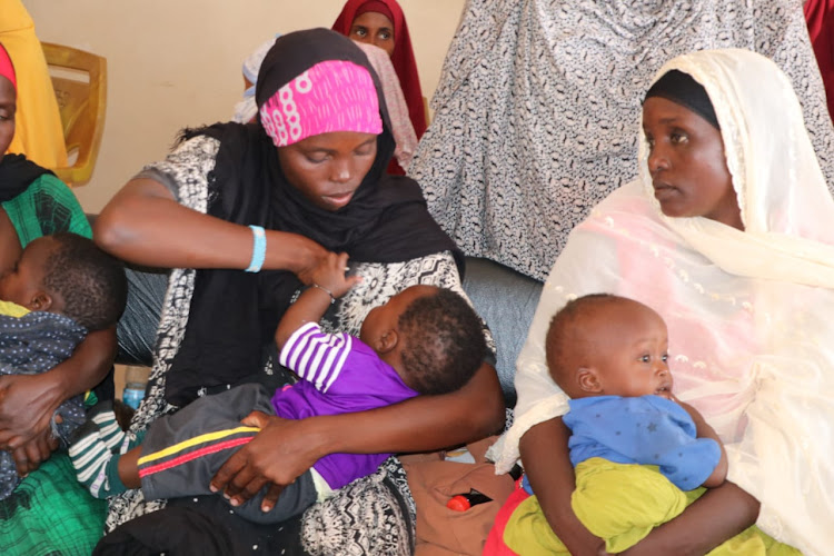 A mother from Bura East in Fafi subcounty, Garissa, breastfeeds her baby on Friday