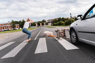 Shocked mother on the crosswalk after pedestrian accident when vehicle hits her baby pram