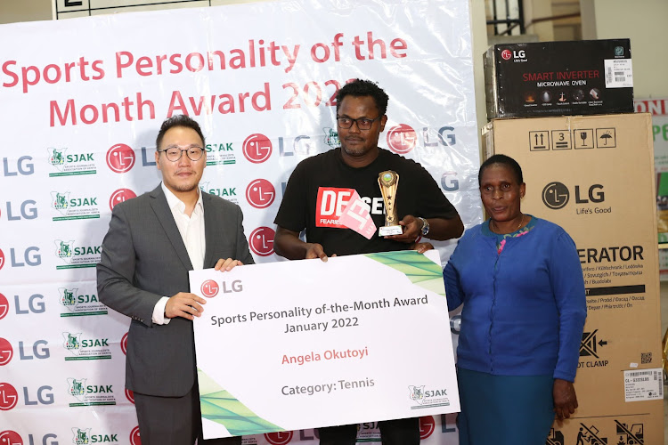 Mary Omukuya (R) receives the LG/SJAK Sports Personality of the Month award from LG Electronics East Africa Marketing Director Changhyun Kim