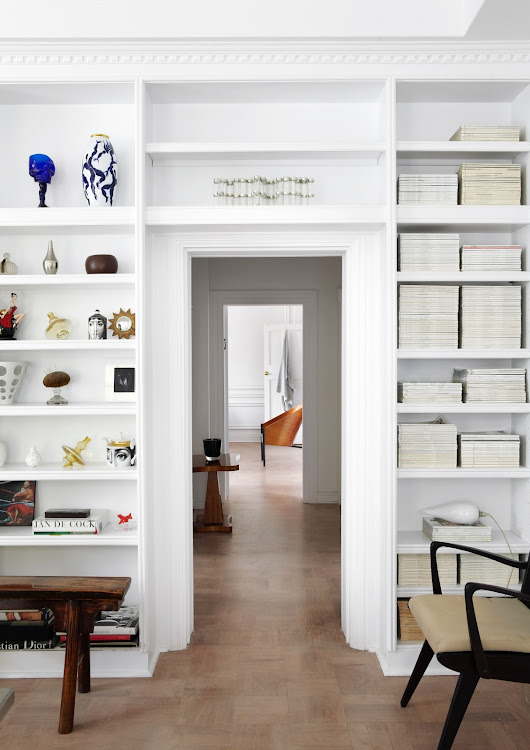 Surrounding the door from the kitchen leading towards the bedroom, the built-in shelves are home to Green’s collection of interior-design magazines, which he can’t bear to part with, and accessories, including examples from his extensive collection of Piero Fornasetti ceramics.