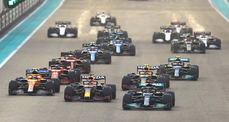 Mercedes' Lewis Hamilton overtakes Red Bull's Max Verstappen at the start of the Abu Dhabi Grand Prix.