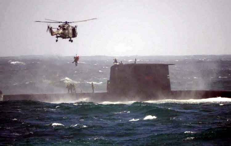 A helicopter hovers above a submarine off Kommetjie during a rescue. Picture: SUPPLIED