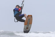 A kite surfer is lifted into the air by wind. The sport is not considered high risk for death.