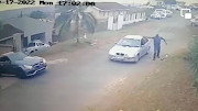 CCTV footage shows a man getting out of a silver BMW and firing shots at the victim, who is about to drive out of his driveway.