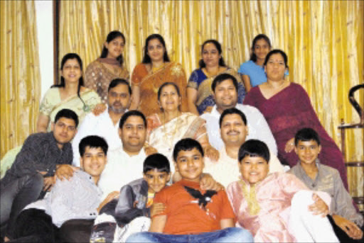 BACK ROW: (from left) Vega, Rajesh’s wife, Arti, Atul’s wife, Chetali and Shubhangi SECOND ROW: The Gupta ’s sister, Achla, her husband, Anil, the Gupta ’s mother, Angoori, Ajay and his wife, Shivani THIRD ROW: Varun, Kamal Kant (in pinstripe shirt), Rajesh, Atul, and Sashank IN FRONT: Aman Kant, Srikant and Surya Kant.