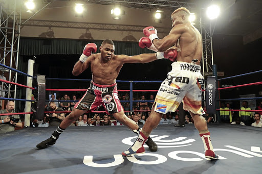 Akani "Prime" Phuzi jabs Congolese Youssof Mwanza in a 12-rounder, to win the WBA Pan African cruiserweight belt. /Nick Lourens