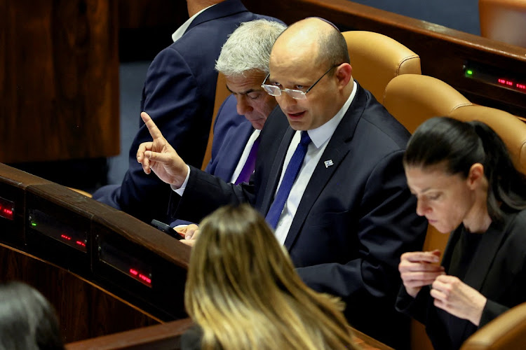 Israeli Foreign Minister Yair Lapid and Prime Minister Naftali Bennett attend a preliminary reading at the Israeli parliament, the Knesset, of a bill to dissolve the parliament, in Jerusalem, June 22, 2022.