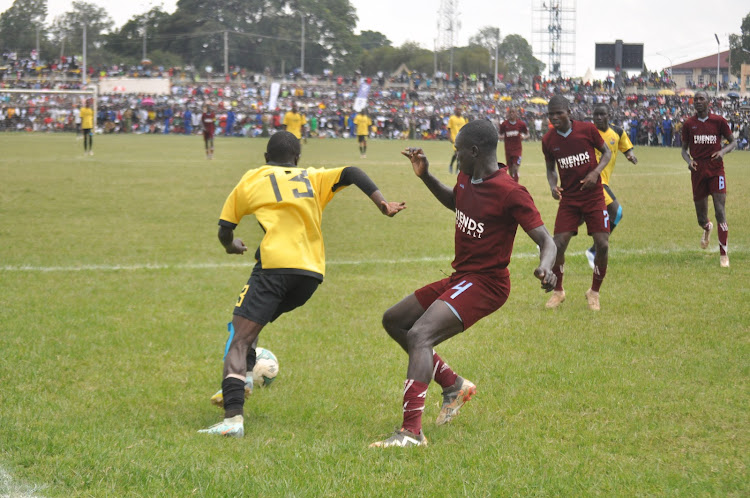 St. Antony's Javan Omondi battles with Dagoretti’s Dismas Ongocho and Stephen Wainaina in the national schools final match at Bukhungu stadium.