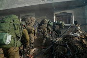 Israeli soldiers operate in the Gaza Strip amid the ongoing conflict between Israel and the Palestinian Islamist group Hamas, in this handout picture released on December 28 2023.      