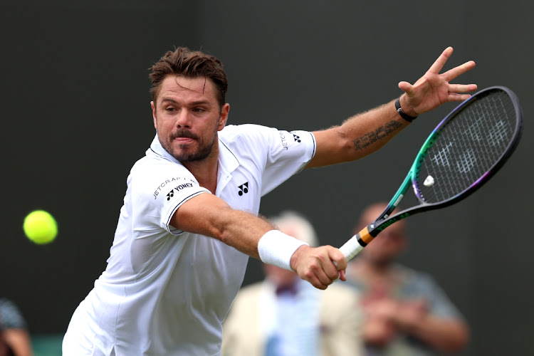 Stan Wawrinka of Switzerland plays a backhand against Tomas Martin Etcheverry of Argentina on day four of The Championships Wimbledon 2023 at the All England Lawn Tennis and Croquet Club on July 6 2023.