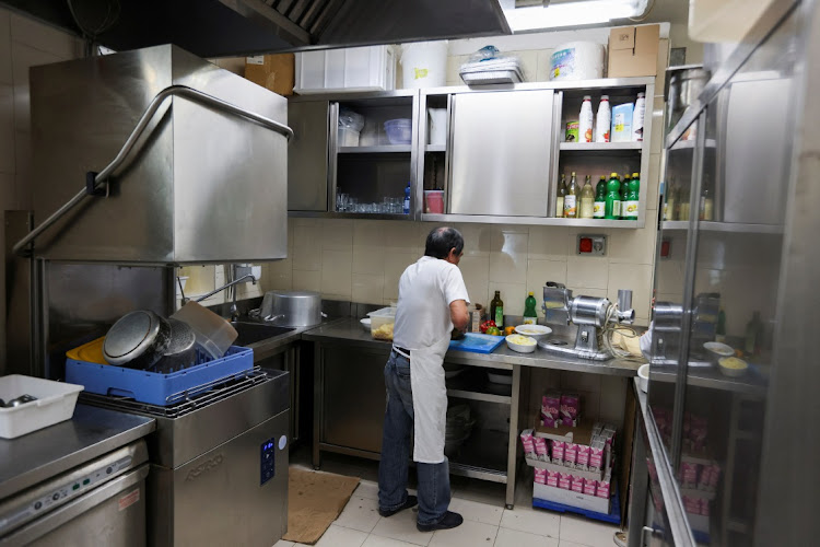 A migrant worker prepares food ar a restaurant prior to lunch time, in Milan, Italy, in this April 26 2023 file photo. Picture: CLAUDIA GRECO/REUTERS