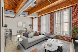 Modern apartment interior with exposed brick, wooden beams, large windows, and stylish furnishings.