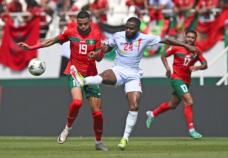 Youssef En-Nesyri (left) of Morocco is tackled by Gedeon Tchingoma Kalulu Kyatengwa of DR Congo during the 2023 Africa Cup of Nations match at Laurent Pokou Stadium in San Pedro, Ivory Coast.