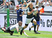 Werner Kok of South Africa goes past Jasa Veremalua of Fiji to score in the corner.   