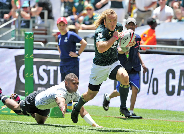 Werner Kok of South Africa goes past Jasa Veremalua of Fiji to score in the corner.