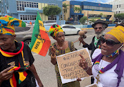 Protesters gather outside an office of the British government to demand the UK pays reparations for centuries of slavery.