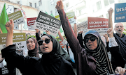 People demonstrate near the Greek consulate in Instanbul, Turkey, to protest against the deadly shipwreck of immigrants and asylum seekers off the coast of Greece.