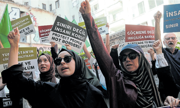 People demonstrate near the Greek consulate in Instanbul, Turkey, to protest against the deadly shipwreck of immigrants and asylum seekers off the coast of Greece.