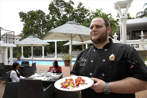 Chef Damian Veneruso with his seared salmon starter at Story restaurant.