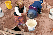 Lisbeth Tapala, fetches water from a hole dug in  a dry riverbed  in Dipere/Nong village at Bakenberg in Mokopane.