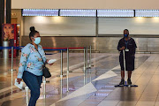 A worker sweeps the floor inside the departures terminal at O.R. Tambo International Airport in Johannesburg, South Africa, on Tuesday, Jan. 11, 2022.  