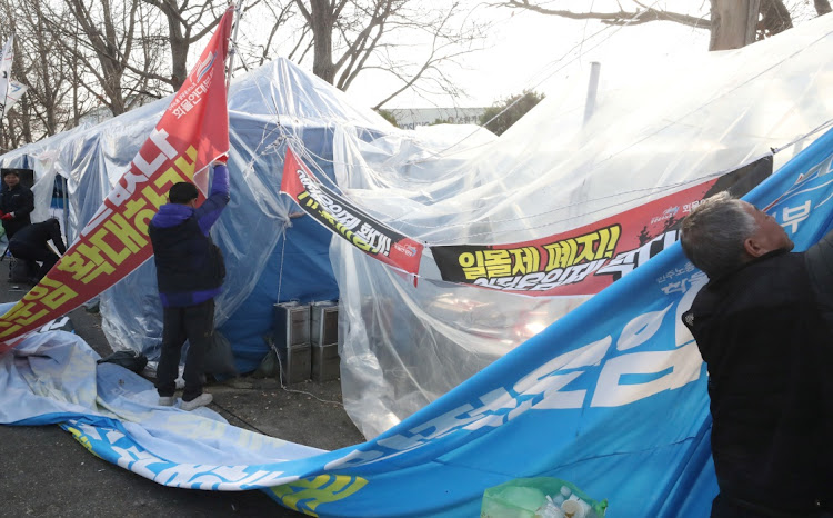 Truckers dismantle the tents they used for striking in Daejeon, south of Seoul, South Korea, on December 9 2022. Picture: YONHAP VIA REUTERS