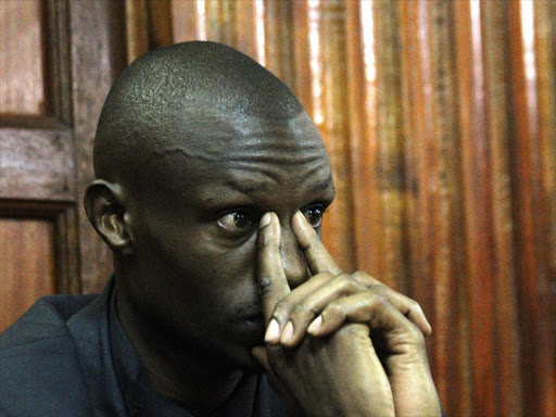 Former journalist Moses Dola at Milimani law courts during the hearing of a case in which he is charged with the murder of his wife Wambui Kabiru, who was an NTV journalist, February 2014. Photo/HEZRON NJOROGE