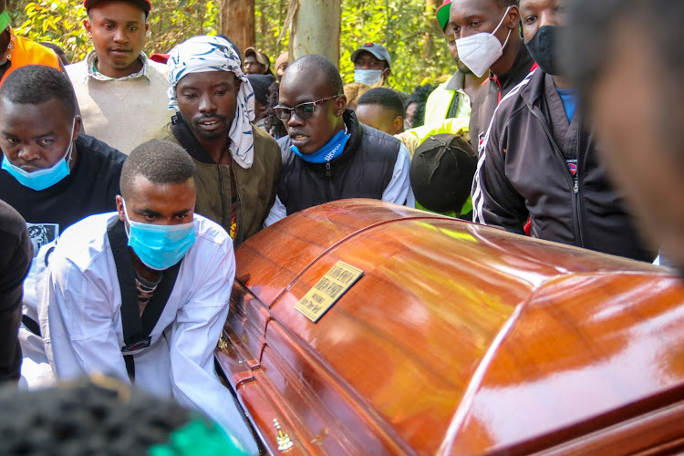 Taekwondo athletes carry the casket of the deceased