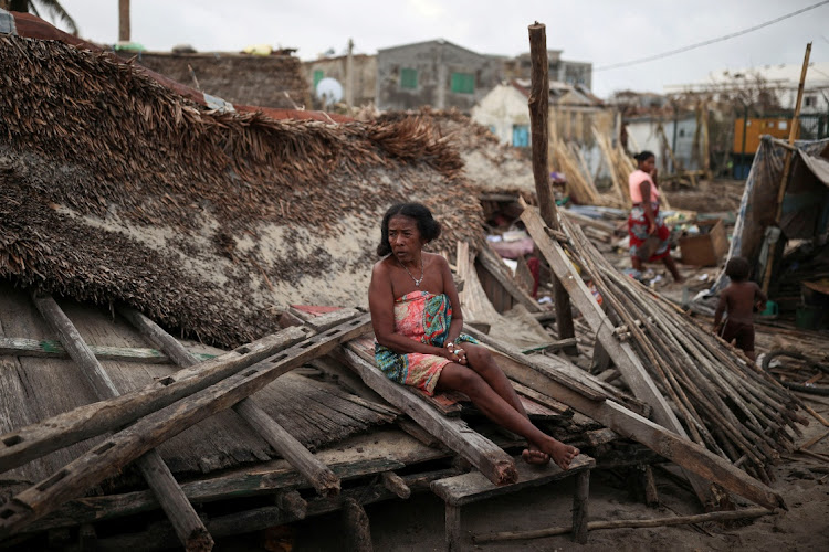 A woman who did not give her name sits on the debris of her destroyed house, in the aftermath of Cyclone Batsirai, in the town of Mananjary, Madagascar, February 7 2022. Picture: ALKIS KONSTANTINIDIS/REUTERS