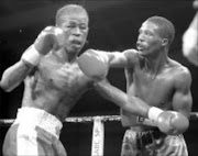 SLUGGERS: Ayanda Yaphi, left, trades blows with Vusumzi Tyatyeka in thier junior welterweight fight at the Baby Champs tournament in Carletonville, North West. Pic.Antonio Muchave. 21/01/2007. © Sowetan.